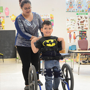 Student in Batman shirt with teacher at private special education school in Mountainside NJ